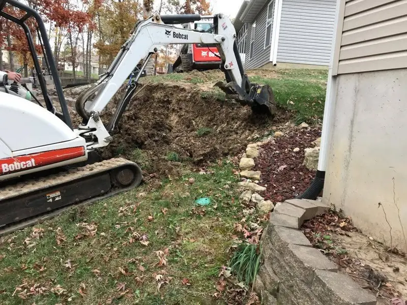 Skid steers excavating and digging near a home in Rolla, MO