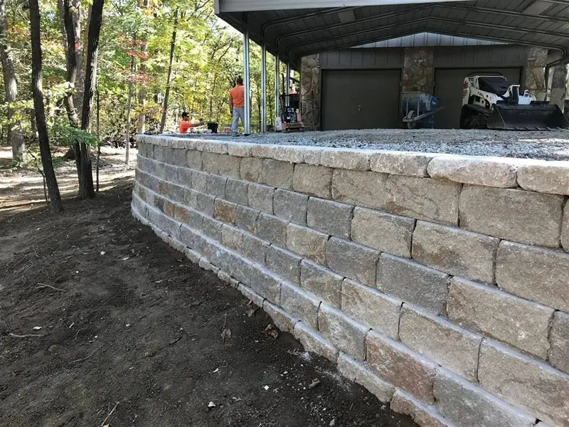 MB General Contracting crew setting block for a retaining wall in Phelps County, MO